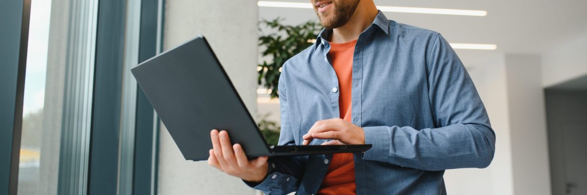A Freelancer Man Works With A Laptop In A Work Coaching Office - AM Contabilidade